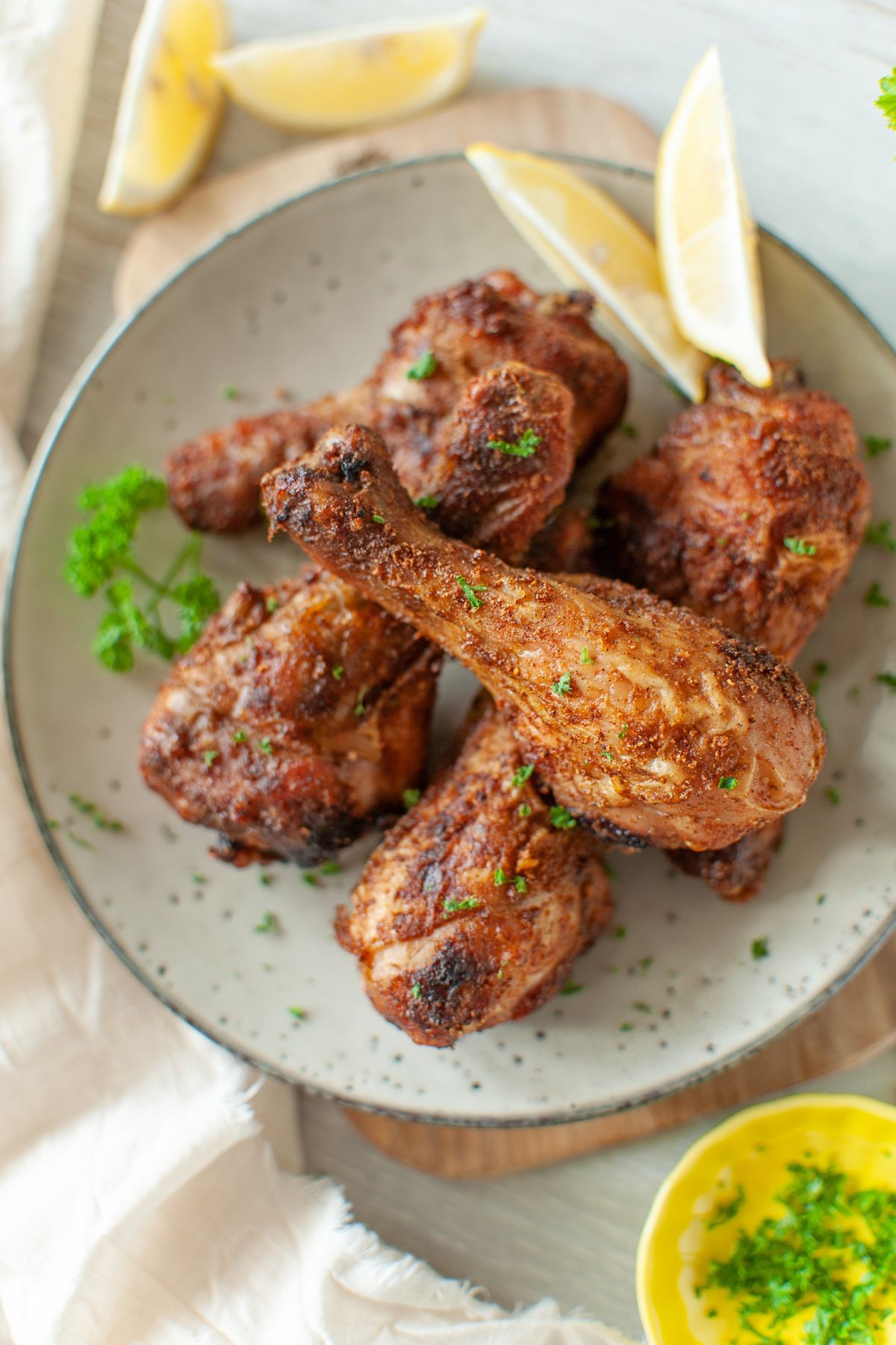 Fried Chicken Legs plated with slices of lemon