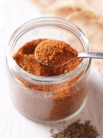 a scoop of BBQ Chicken Dry Rub from a jar