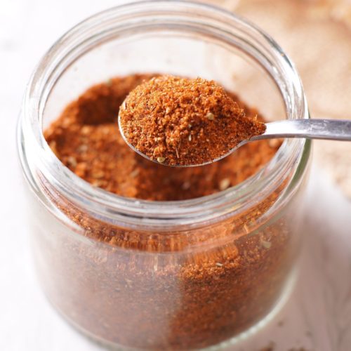 a scoop of BBQ Chicken Dry Rub from a jar