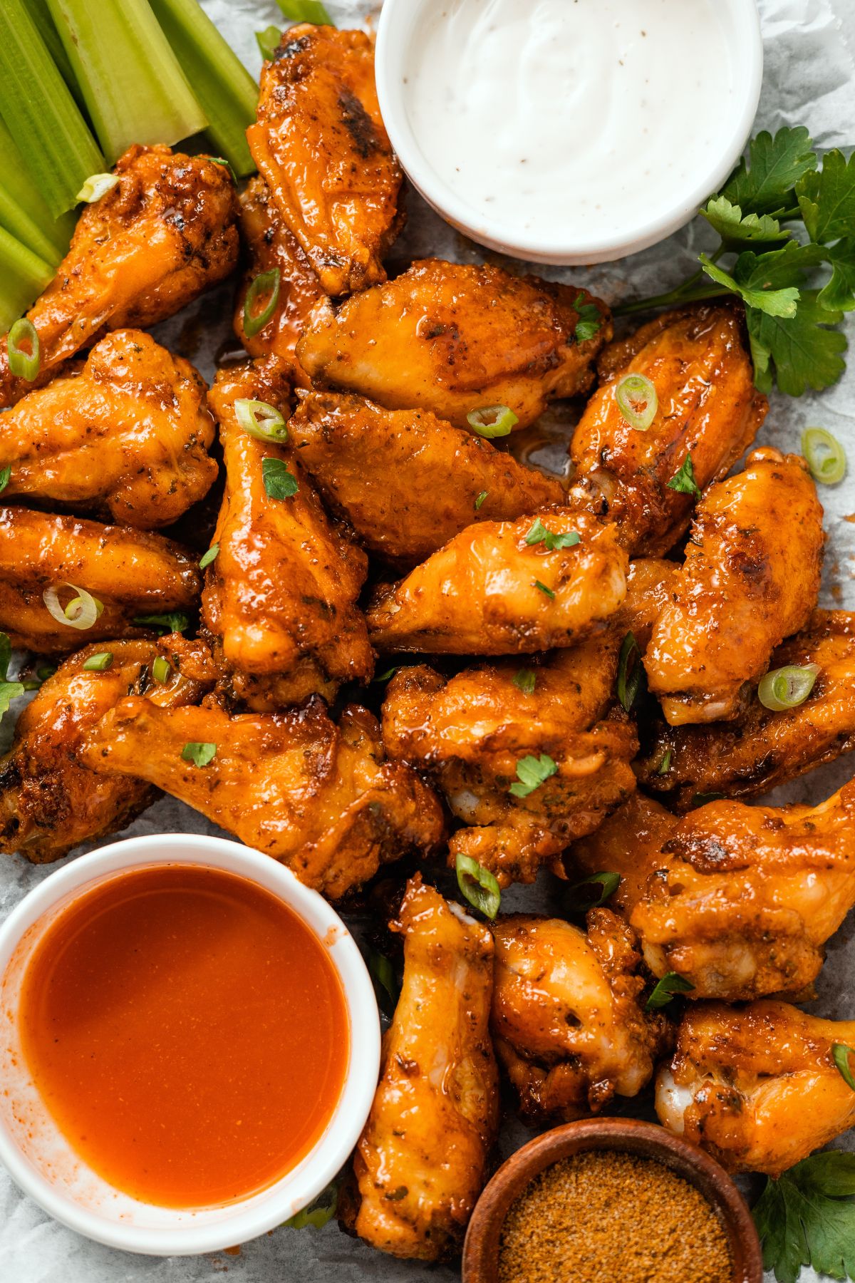 juicy Honey Buffalo Wings with dips on the side and celery sticks