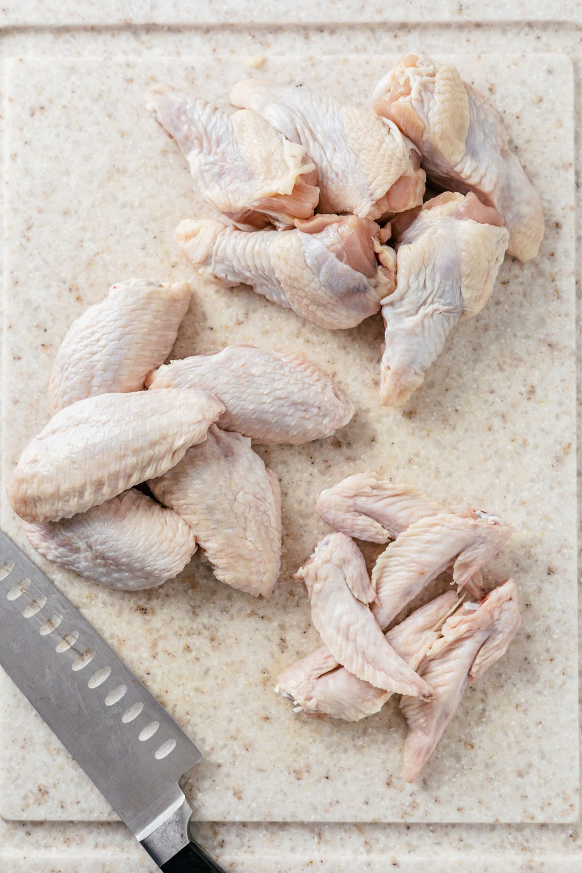 raw chicken wings cut into three distinct parts: the chicken drumette, flat wing or middle section, and the wing tip.