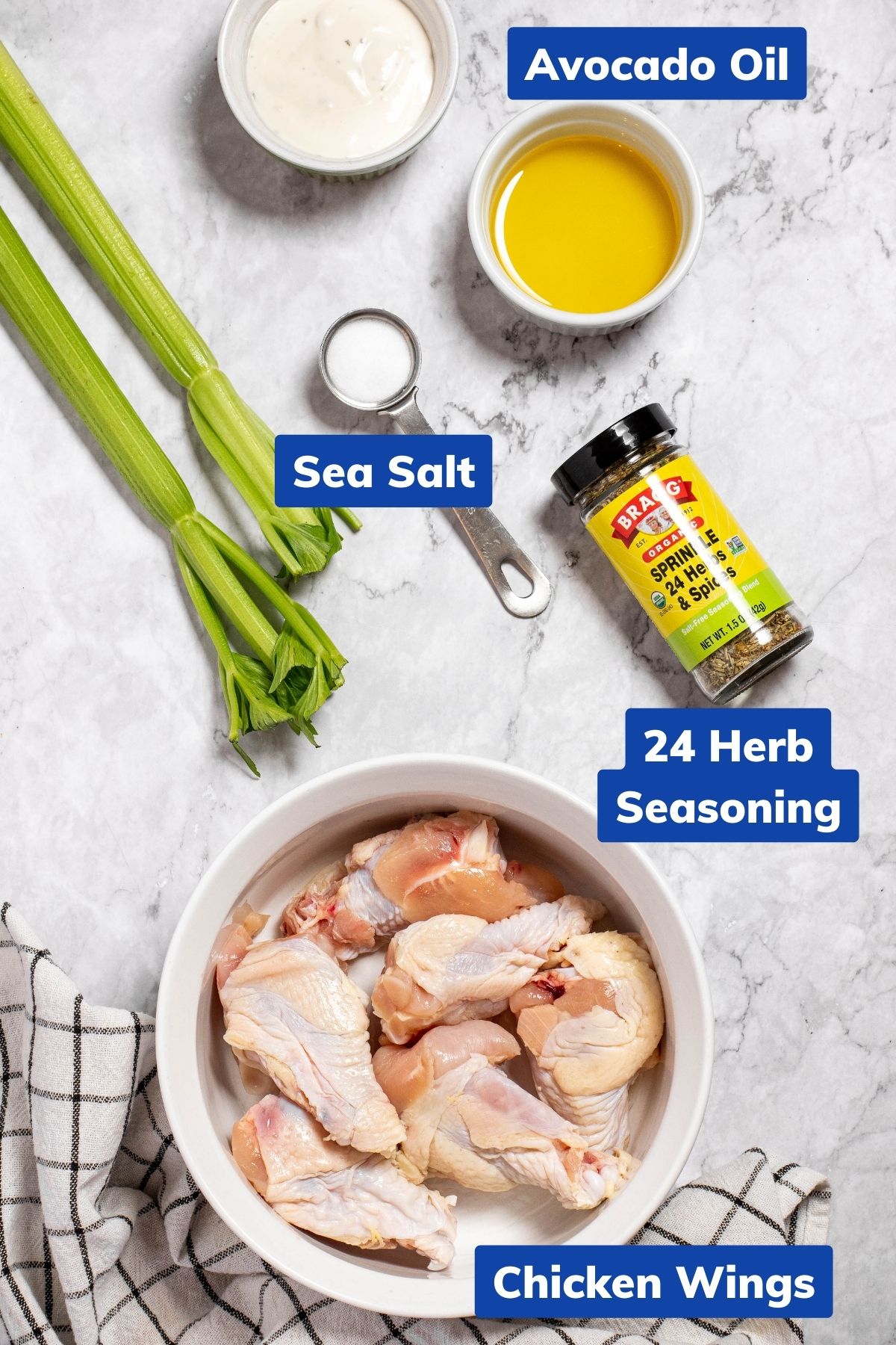 ingredients needed to make ninja foodi chicken wings: avocado oil, sea salt, 24 herb seasoning and chicken wings in separate bowls