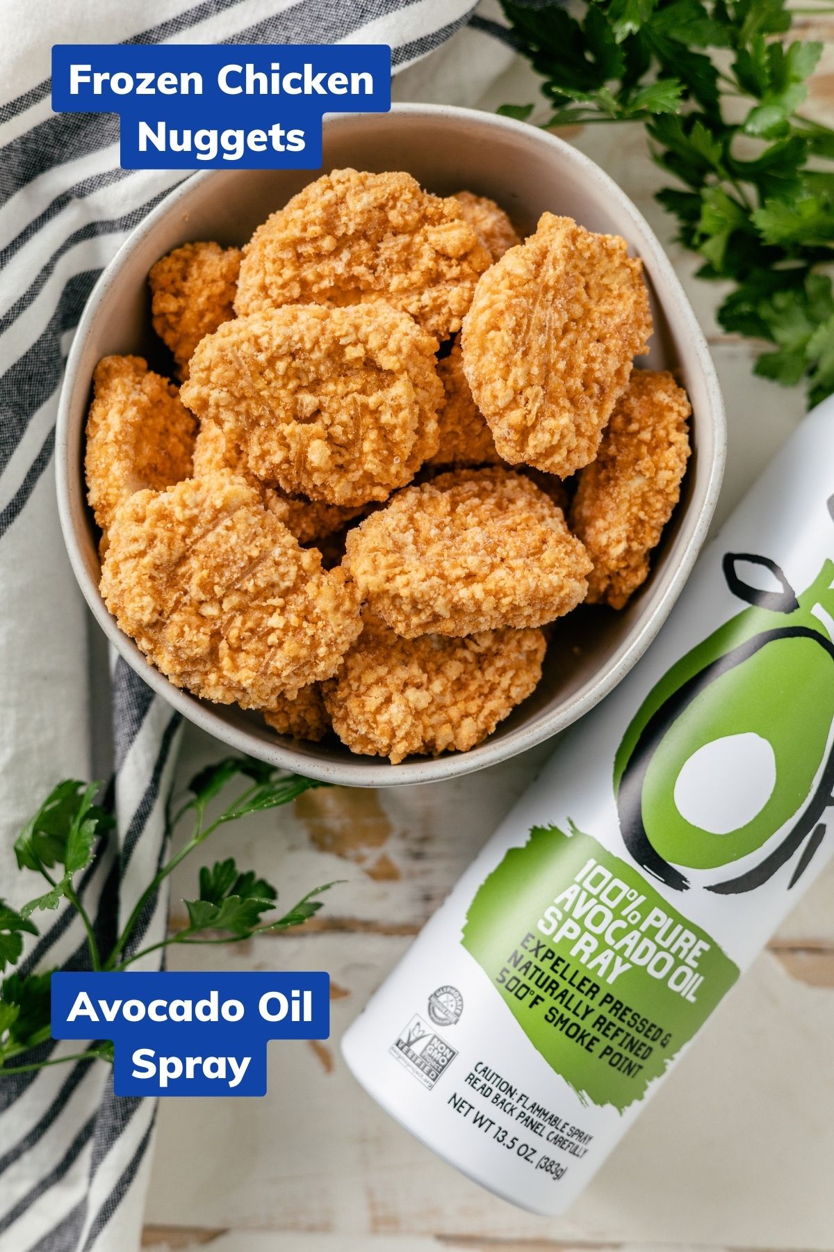 frozen chicken nuggets in a large bowl beside an avocado oil spray