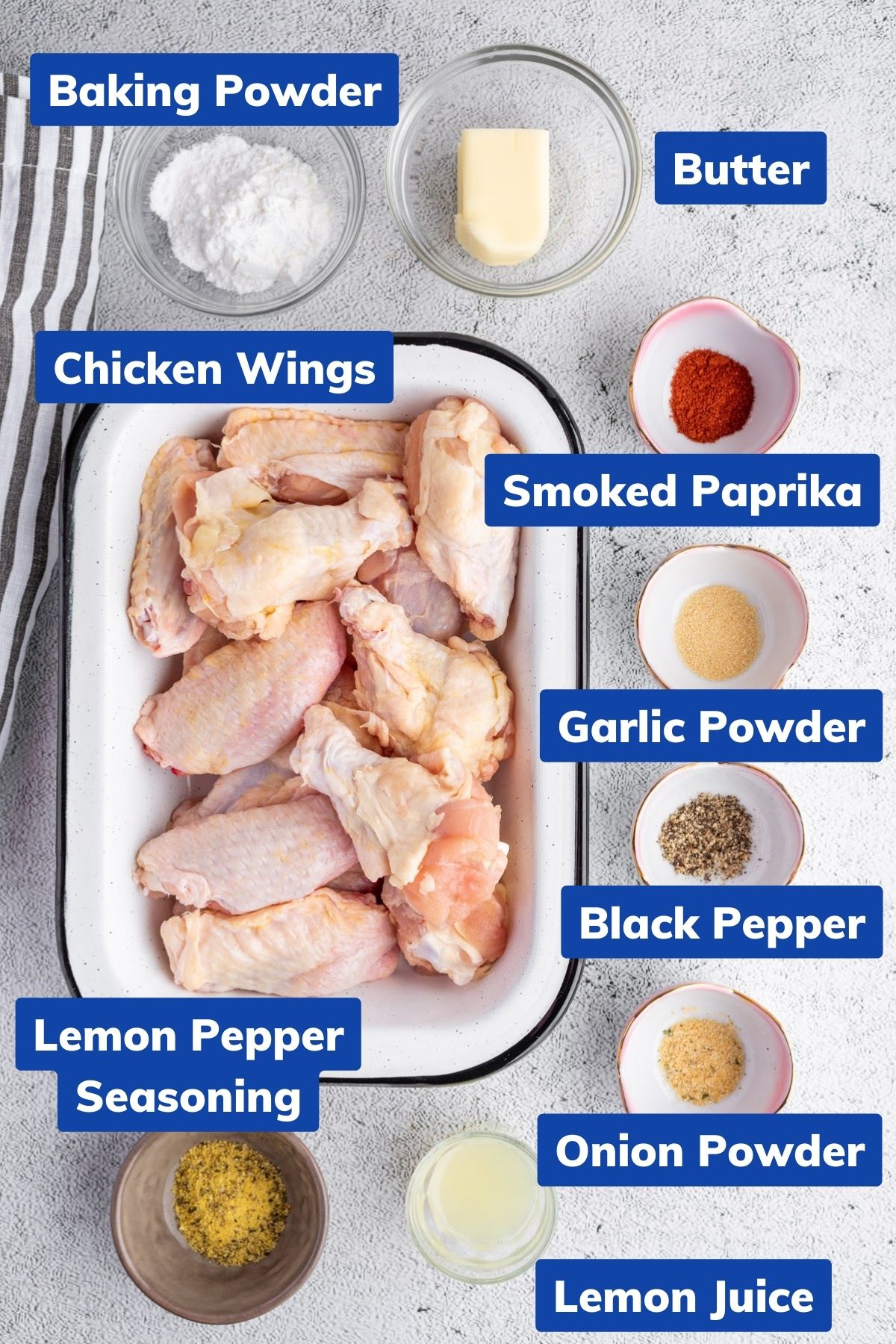 ingredients needed to make lemon pepper air fryer wings like chicken wings, baking powder, butter, smoked paprika, garlic powder, black pepper, onion powder, lemon juice and lemon pepper seasoning in separate bowls