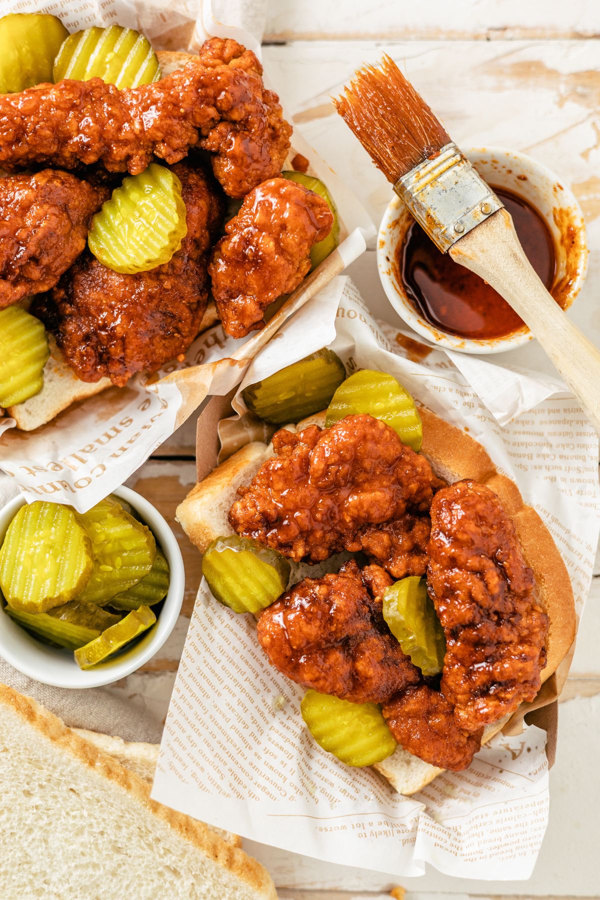 Nashville Hot Chicken Tenders in a basket with pickles and white bread