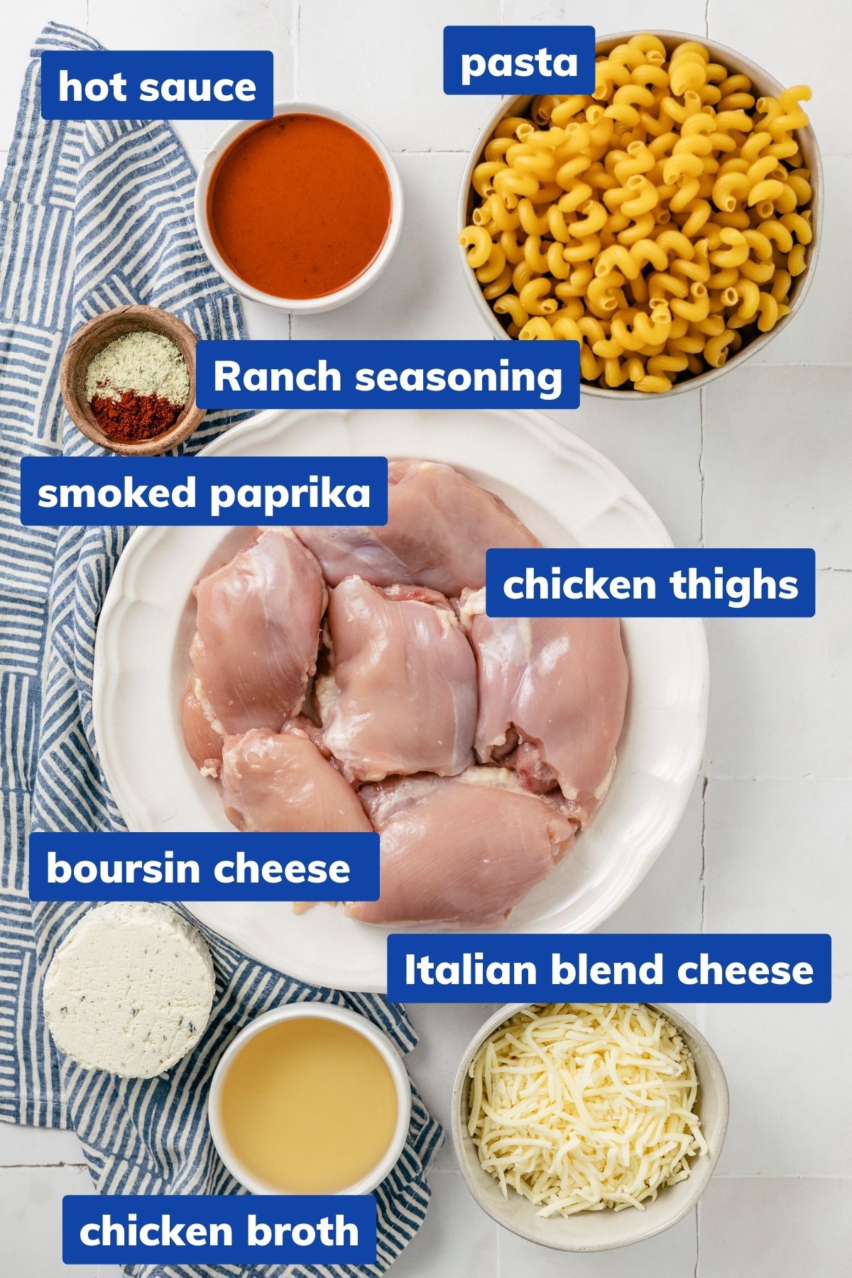 ingredients to make buffalo chicken pasta: Chicken thighs, Ranch seasoning, Smoked Paprika, Hot sauce, Chicken broth, Boursin cheese, Italian blend cheese, Pasta on separate bowls
