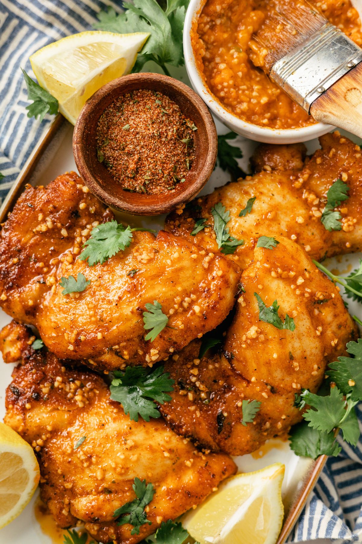 close-up shot of Cajun Chicken Thighs in a large dish with cajun garlic butter