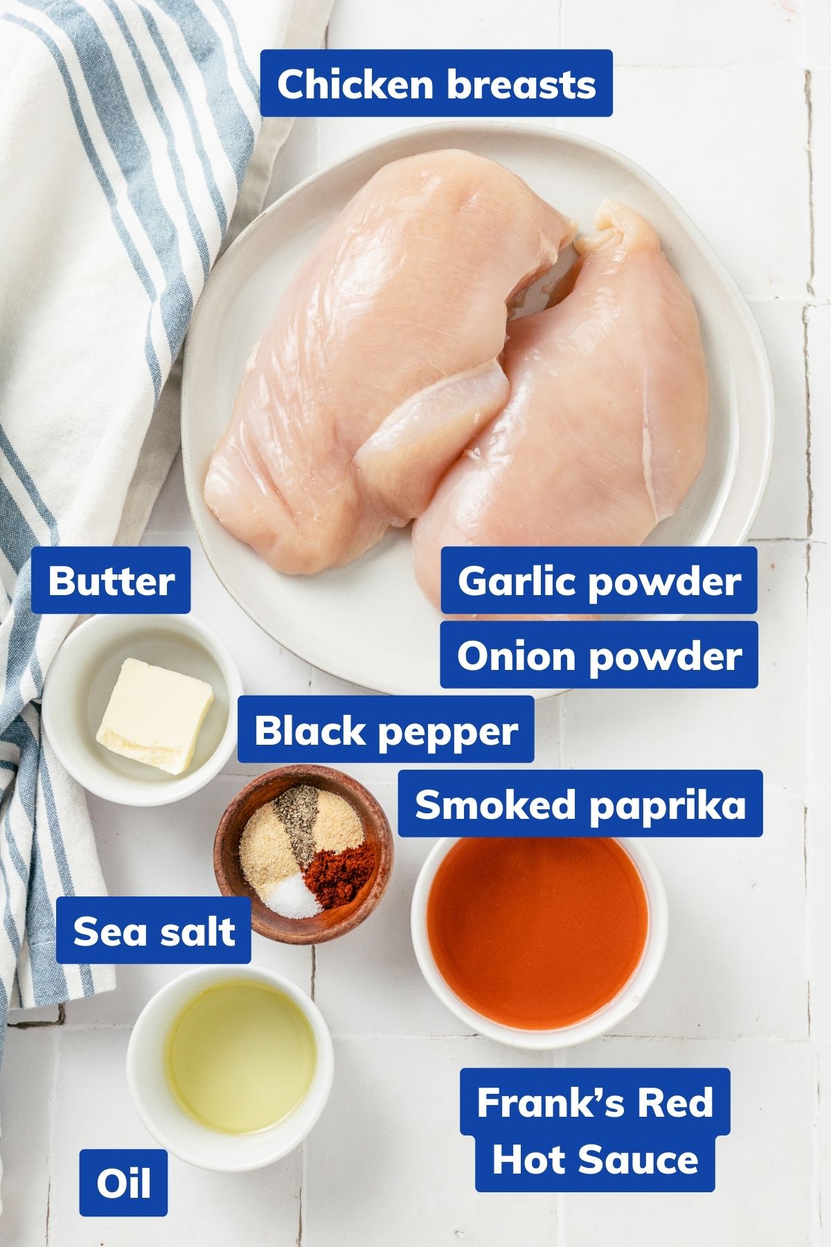 ingredients needed to make air fryer buffalo chicken breasts: chicken breasts, butter, garlic powder, onion powder, black pepper, smoked paprika, sea salt, oil, and hot sauce on separate bowls