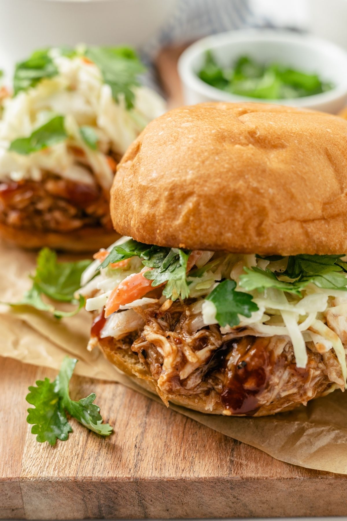 Tasty and satisfying BBQ chicken sliders on sweet Hawaiian rolls with coleslaw and cilantro