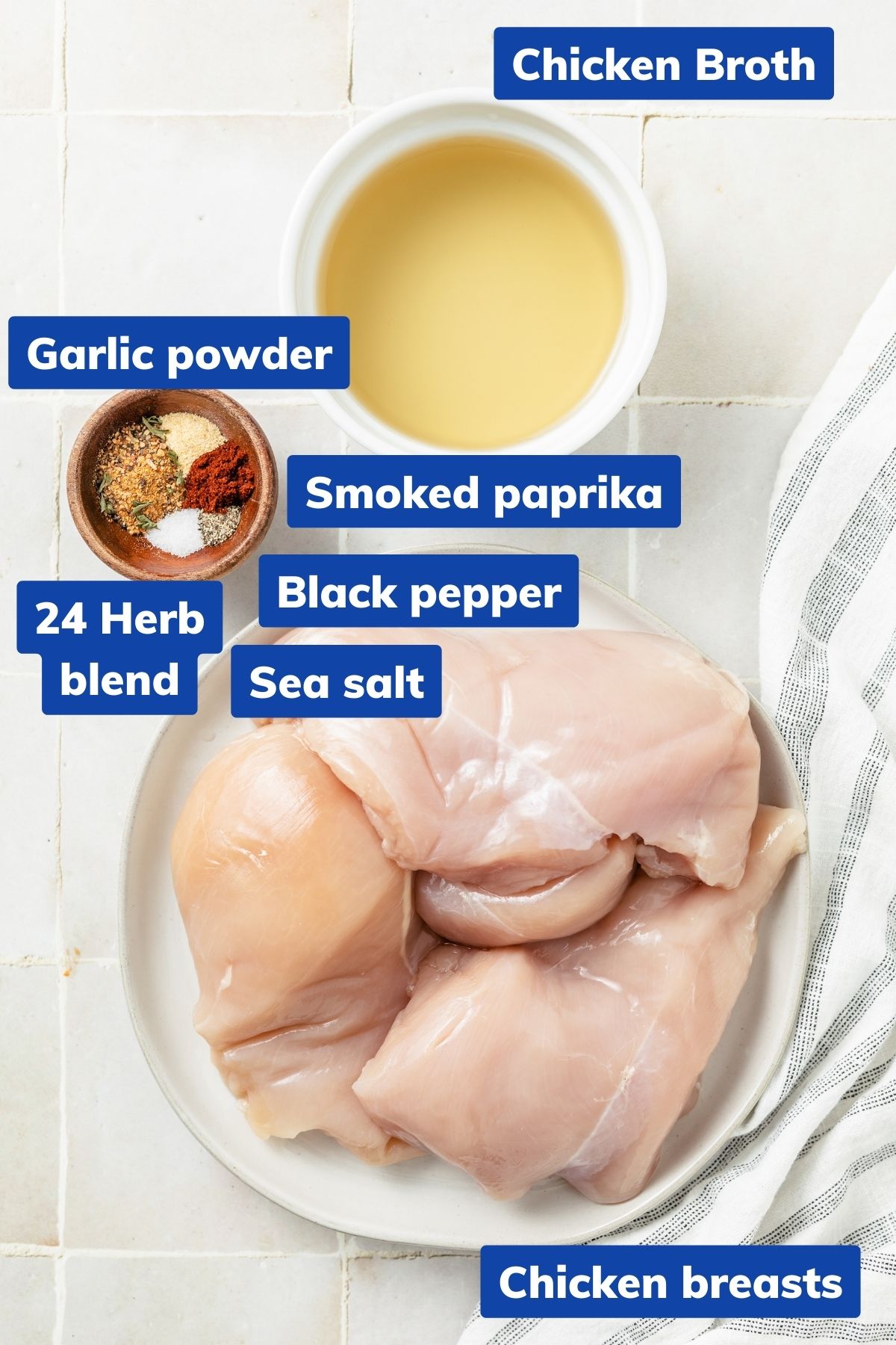 ingredients needed to make instant pot shredded chicken breast: Bowls of raw chicken, chicken broth, 24 herb blend, garlic powder, smoked paprika, sea salt, and black pepper ready for cooking.