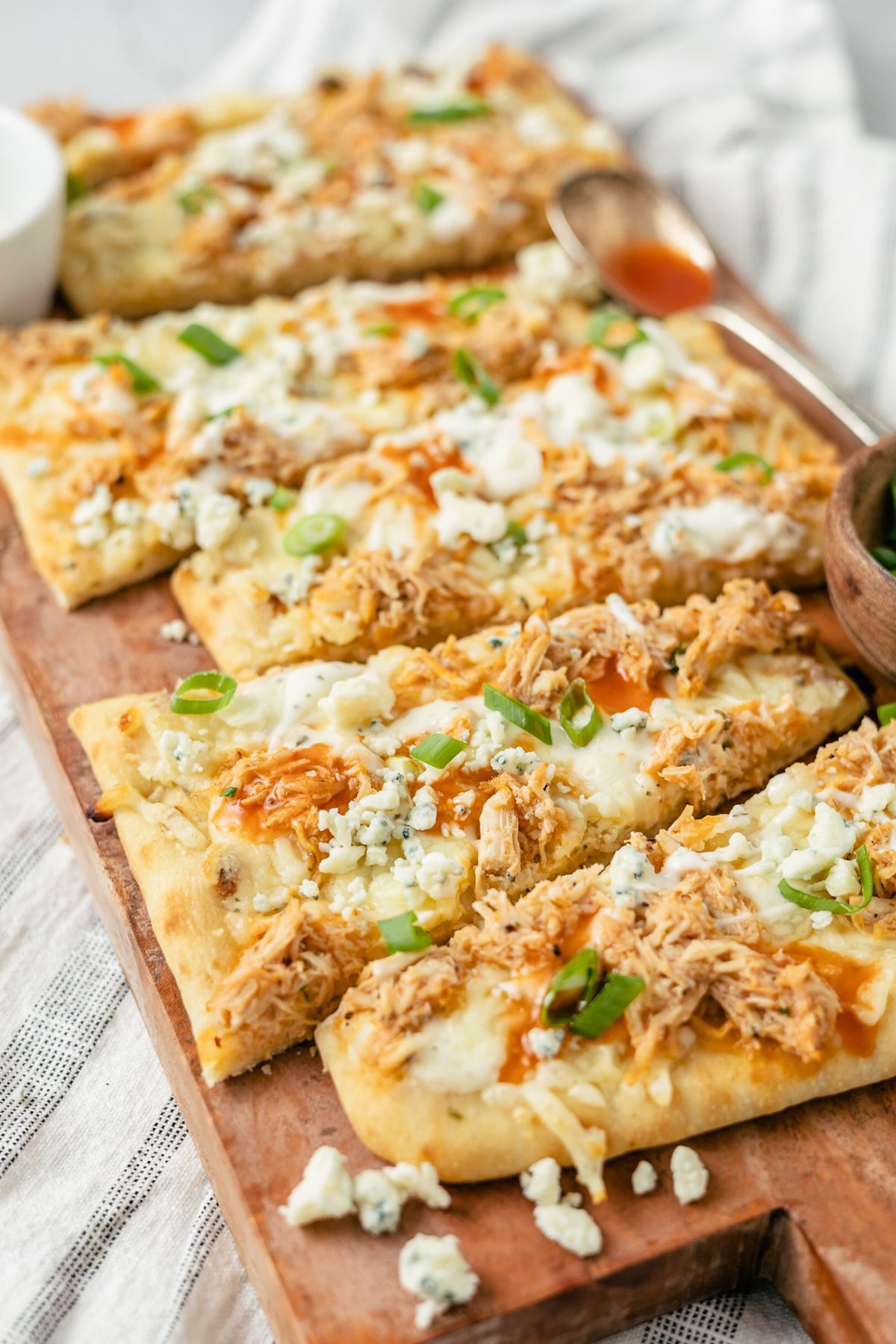 Mouthwatering Buffalo Chicken Flatbreads beautifully arranged on a rustic wooden board, a delectable feast.