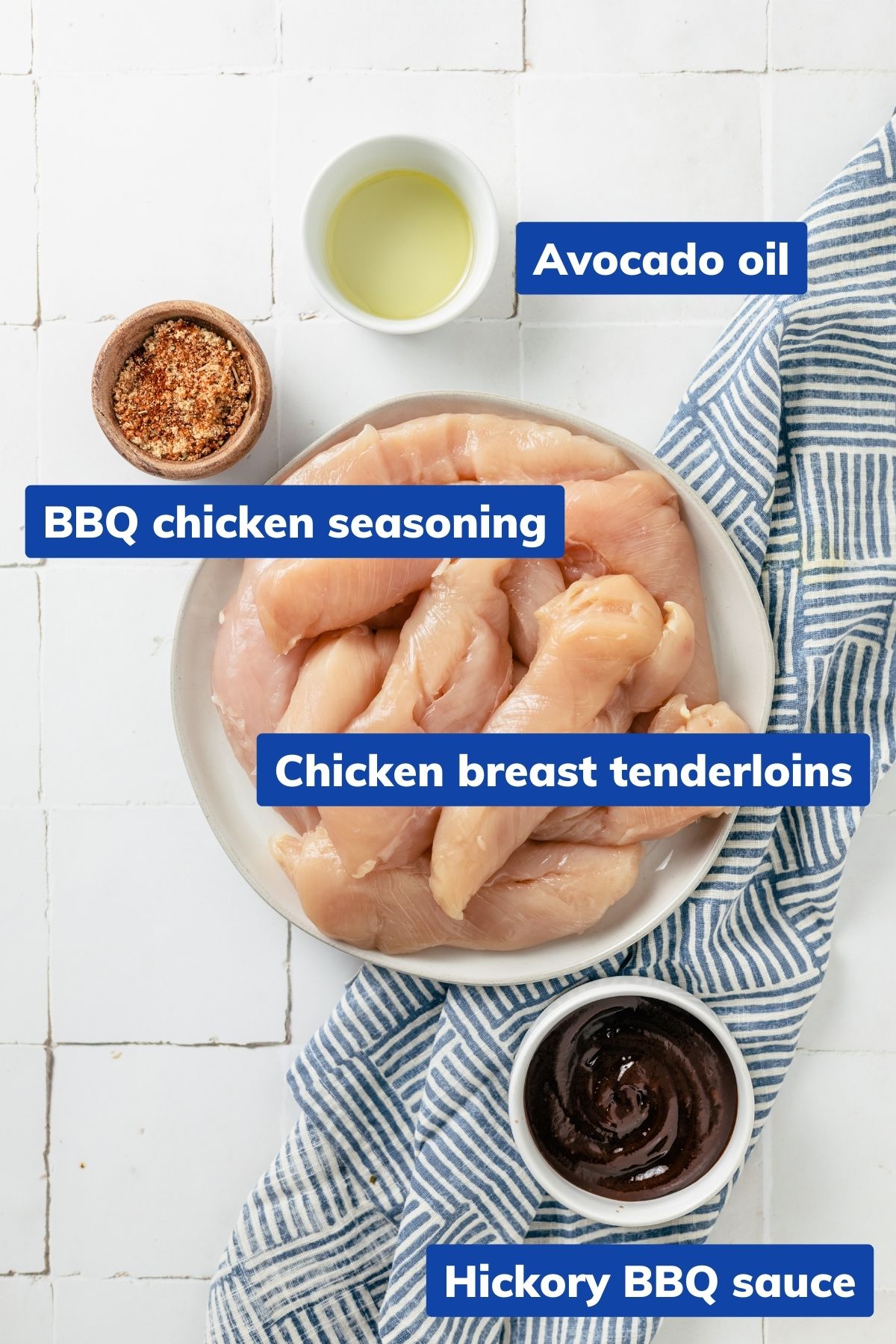 Ingredients for BBQ Chicken Tenders: tenderloins, BBQ seasoning, avocado oil, and hickory BBQ sauce in separate bowls