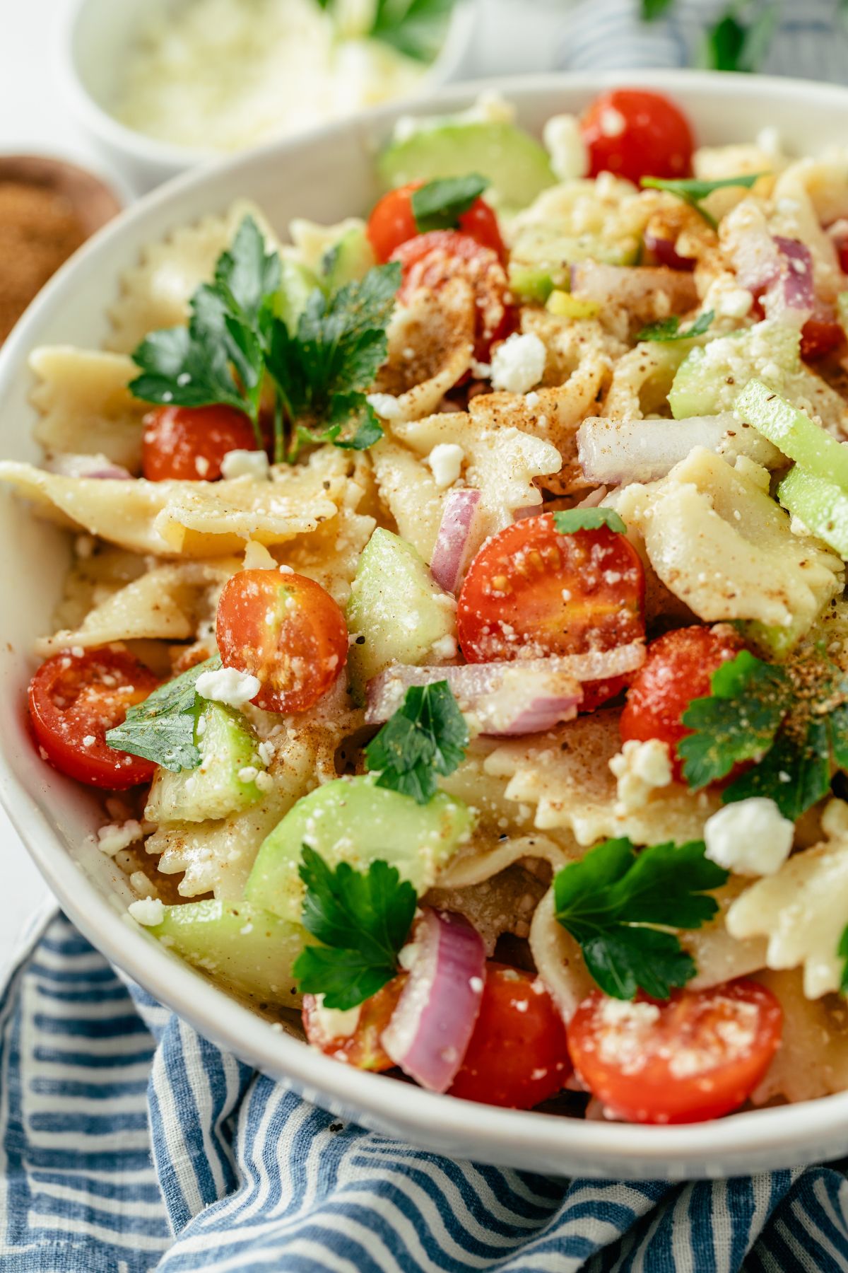 Bowtie Pasta Salad in a large bowl, bursting with colorful ingredients and creamy dressing.