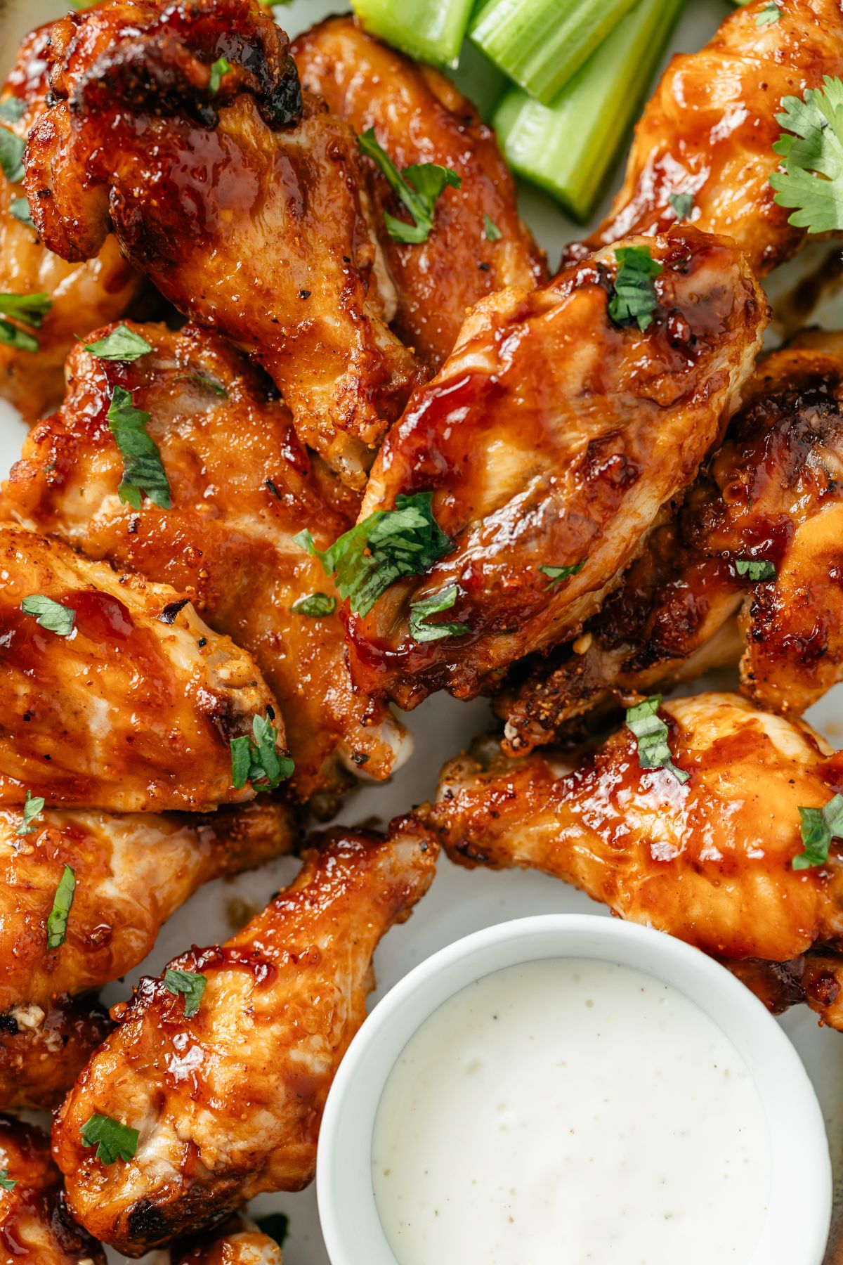 Golden-brown air-fried frozen chicken wings arranged on a platter, crispy on the outside and juicy on the inside, garnished with a sprinkle of fresh herbs.